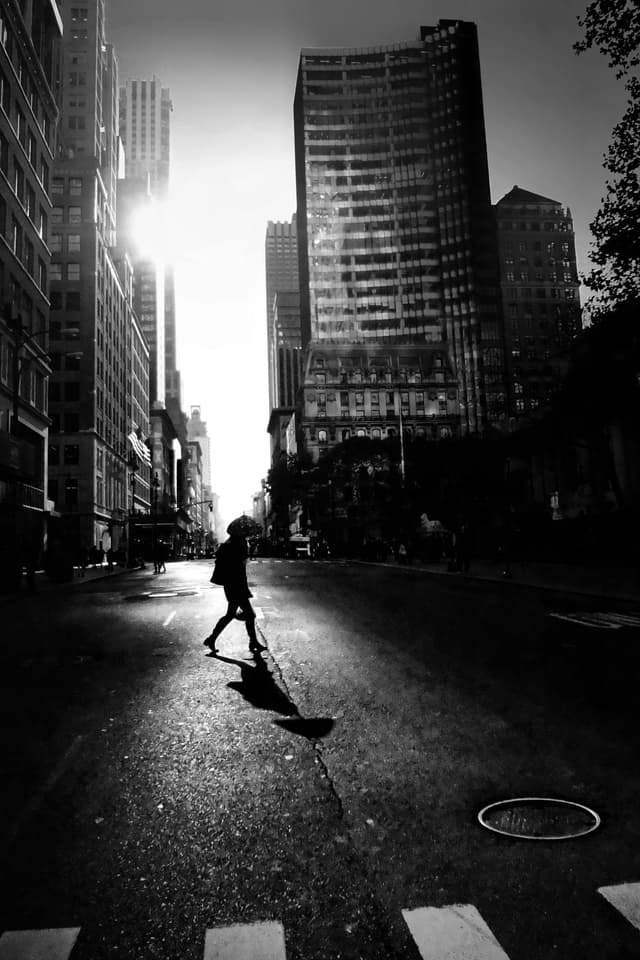 Woman walking at sunset in NY with her bedside lamp